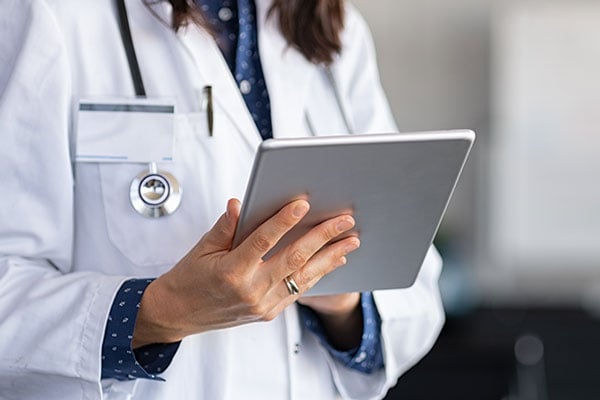 A doctor using a tablet